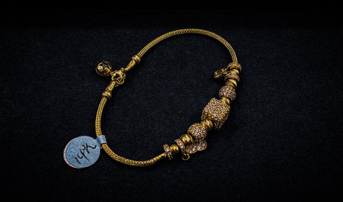 14K GOLD CHARM BRACELET (6.5 DWT)
